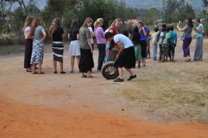 an impromptu gathering with children just outside the gates to Springs of Hope's permanent site. Notice Rachel trying to roll a tire with two sticks. She was inspired by the village boys--who were experts at it!