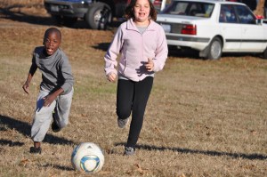 Patrick and Maddie chasing down a ball during a fierce game of soccer at my sister's house last fall.
