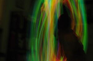 At one of Wheaton Academy's bball games not long ago, the students brought glow-in-the-dark bracelets/necklaces. After the game, PJ gathered as many as he could, and we had a light show/photo shoot that night at home. Here he is twirling a handful of them.