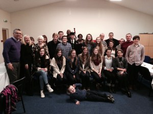 post host-family supper--all guests, including the piper in the middle