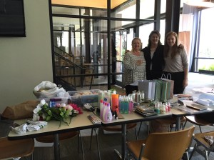 Rez's New Name team members standing behind the gifts donated by WA girls' soccer team